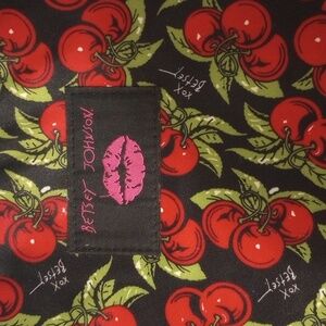 Betsy Johnson computer bag in a cherry print with a black background